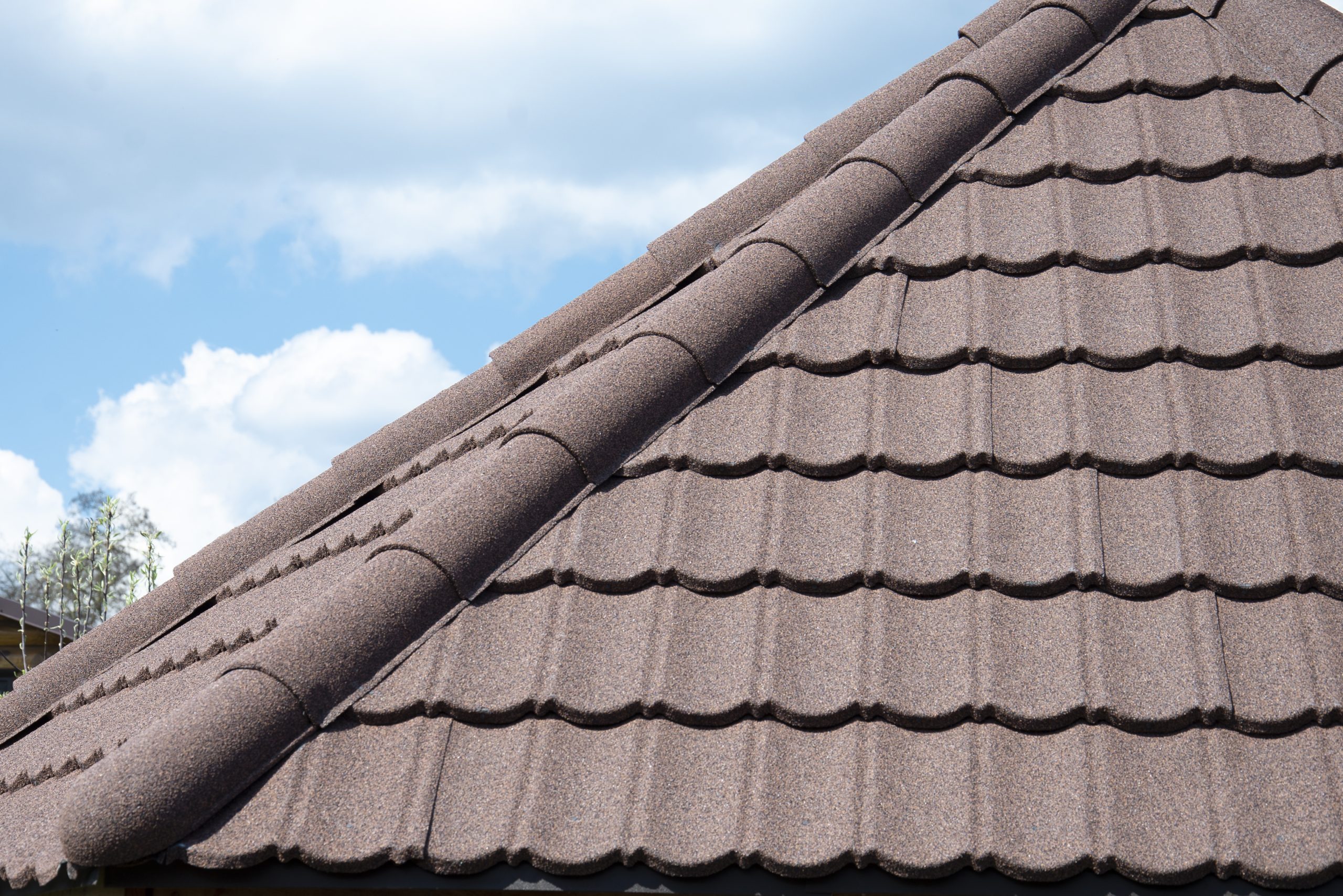 Composite roof tile on house against blue sky